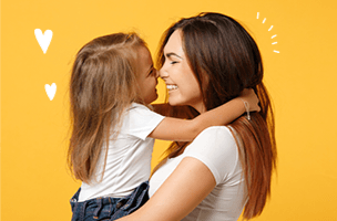 A caregiver and young child sharing a hug in a Zumbini promotional photo.